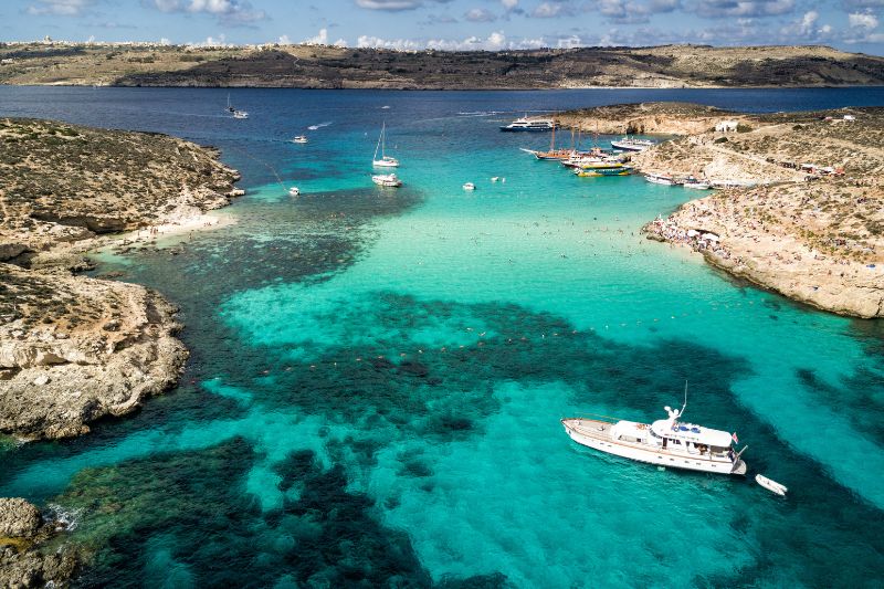 The Blue Lagoon from the air with boats and swimmers in the background.